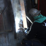 Bucket repair - man welding