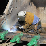 Bucket repair - man welding inside
