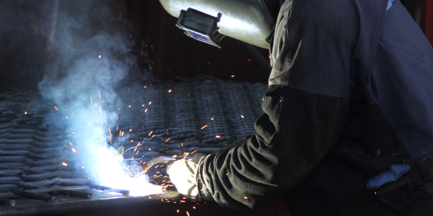 Man welding a screen