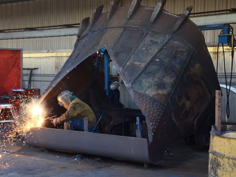 Welder working on equipment inside