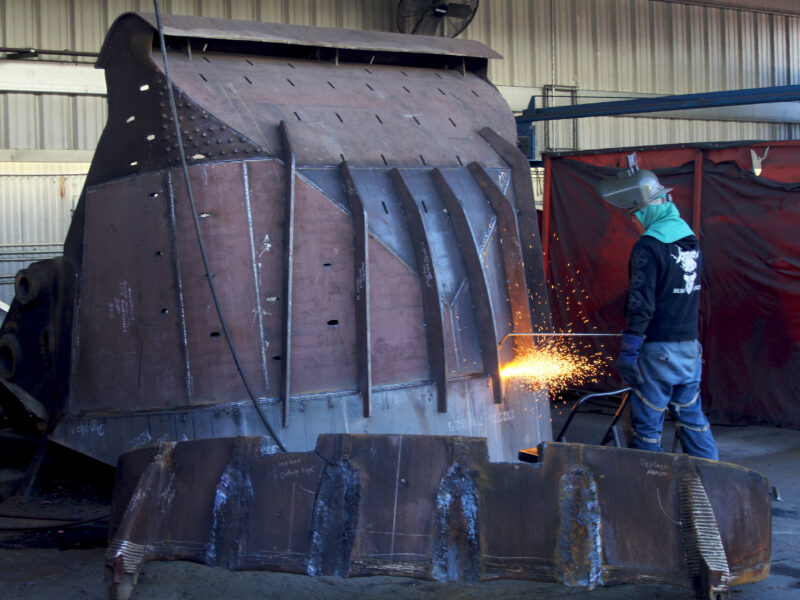 Welder standing working on equipment