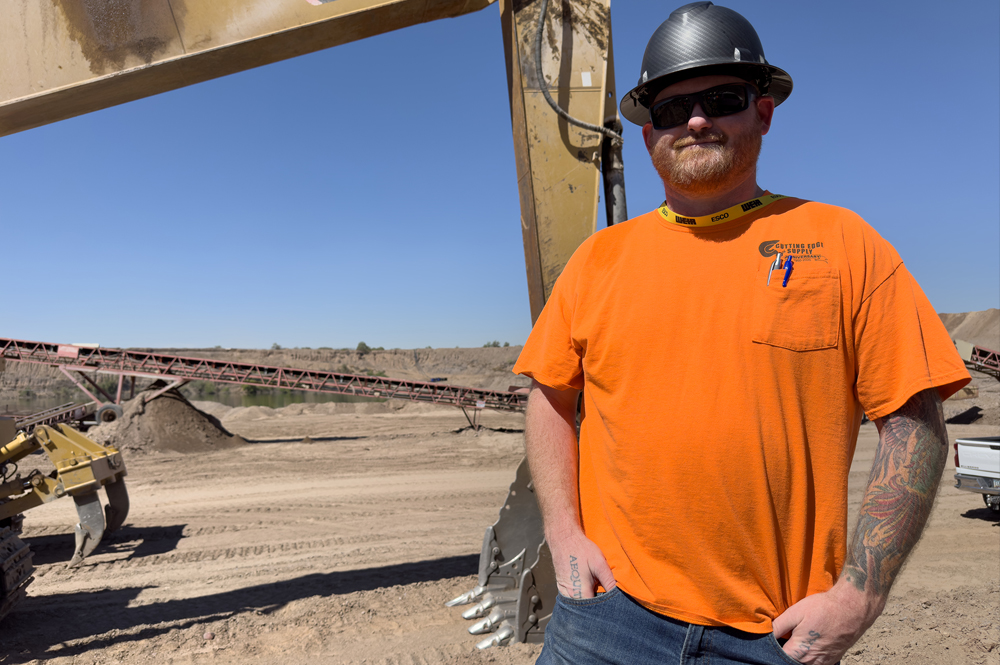 Man in front of heavy equipment