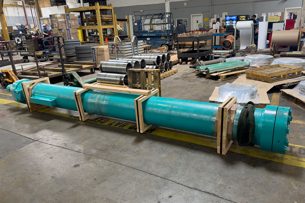 Warehouse interior with large metal cylinder on ground.
